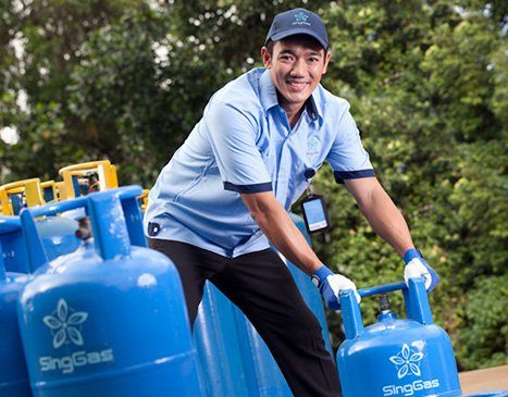 Singgas Employee holding LPG Tank