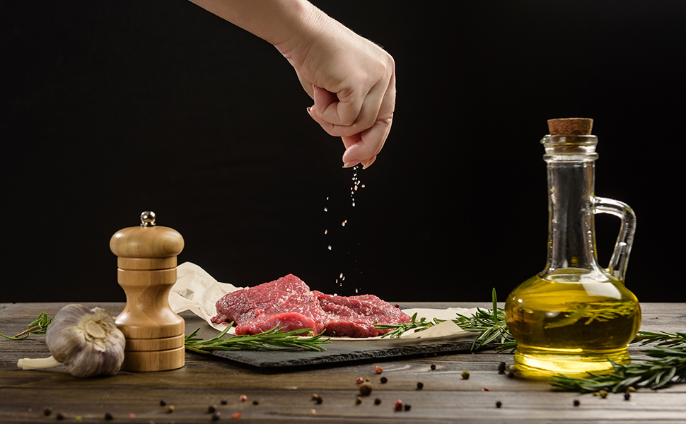 image of meat getting seasoned